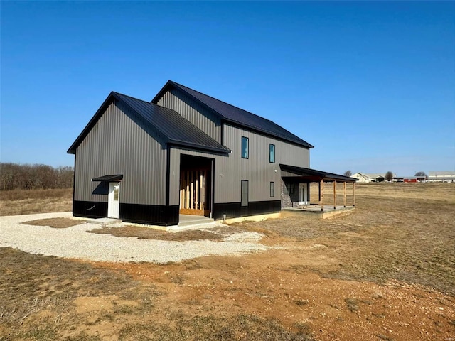 rear view of house featuring metal roof