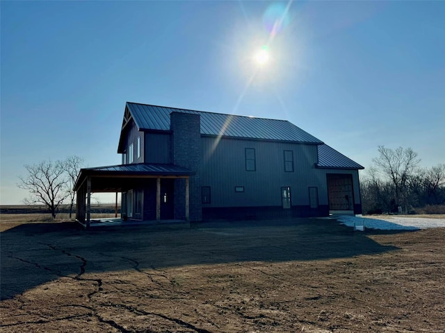 view of front of home featuring a standing seam roof, metal roof, and an attached garage