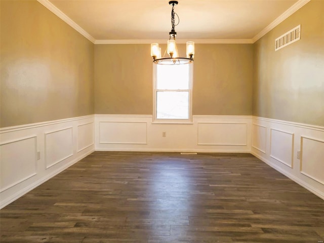 unfurnished dining area with a wainscoted wall, visible vents, ornamental molding, dark wood-style floors, and an inviting chandelier