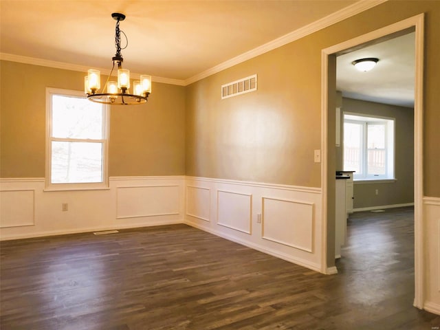 unfurnished room with dark wood-style floors, visible vents, a wainscoted wall, and ornamental molding