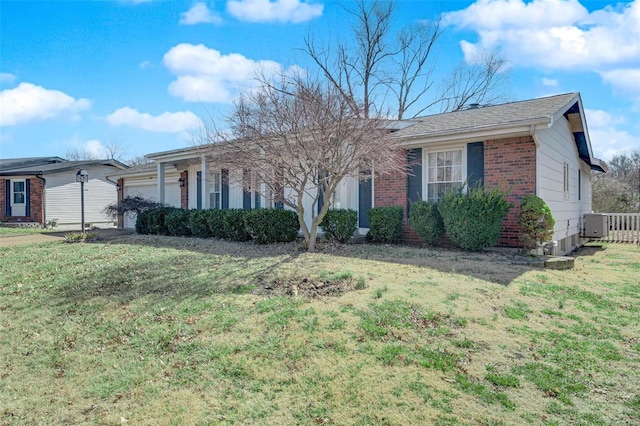 single story home featuring a front yard, brick siding, and an attached garage