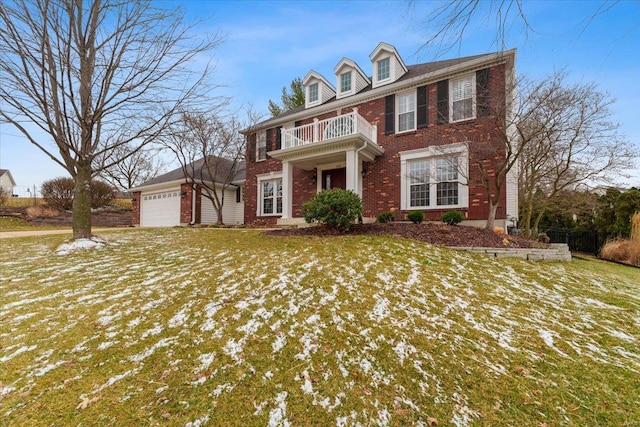 georgian-style home featuring brick siding and a balcony