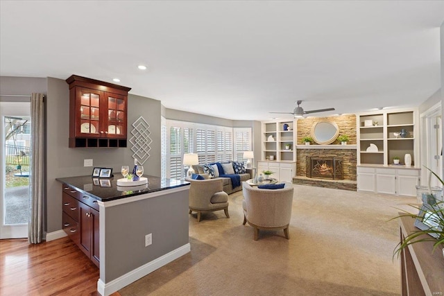 living area featuring ceiling fan, recessed lighting, light colored carpet, a fireplace, and baseboards