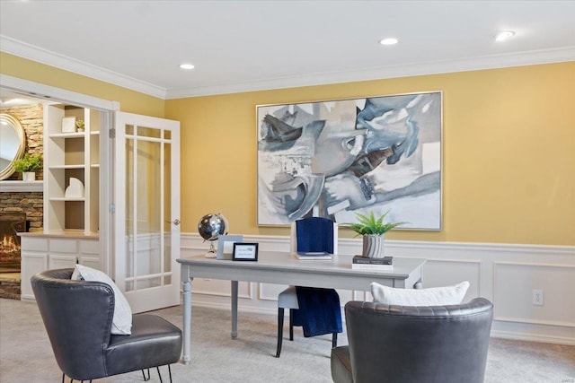 carpeted office with french doors, a wainscoted wall, crown molding, a fireplace, and recessed lighting