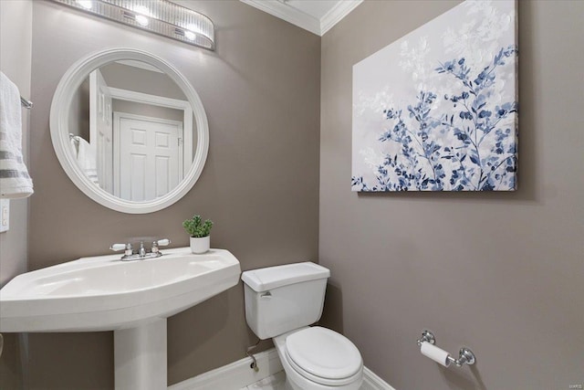 bathroom featuring toilet, baseboards, and ornamental molding