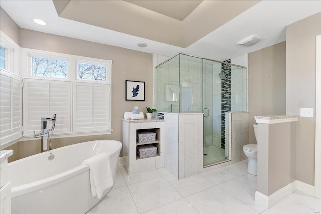 full bathroom featuring a soaking tub, a shower stall, marble finish floor, and baseboards