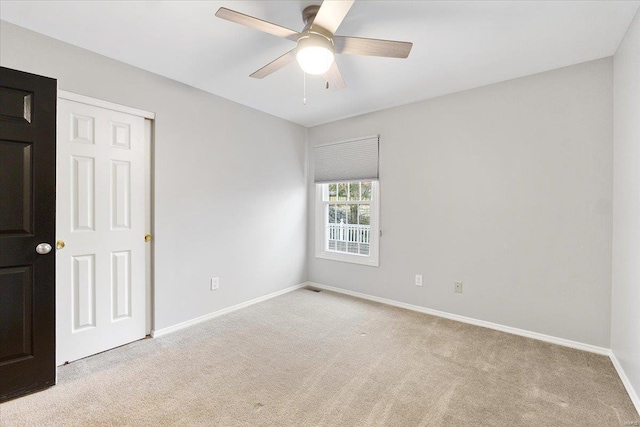 unfurnished bedroom with carpet floors, ceiling fan, visible vents, and baseboards