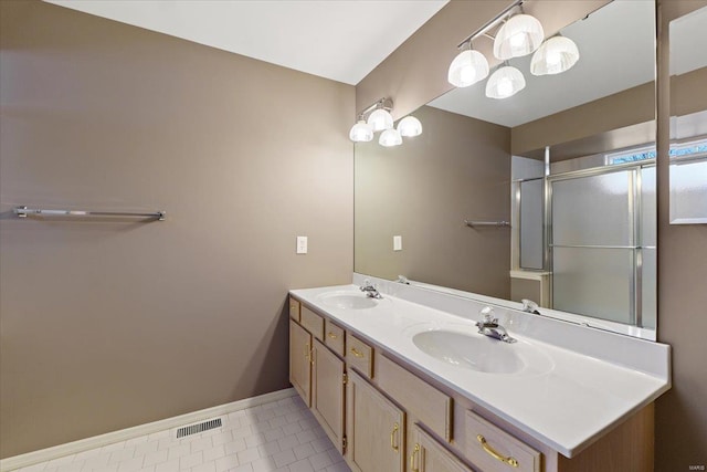 full bath featuring double vanity, visible vents, a sink, and an enclosed shower