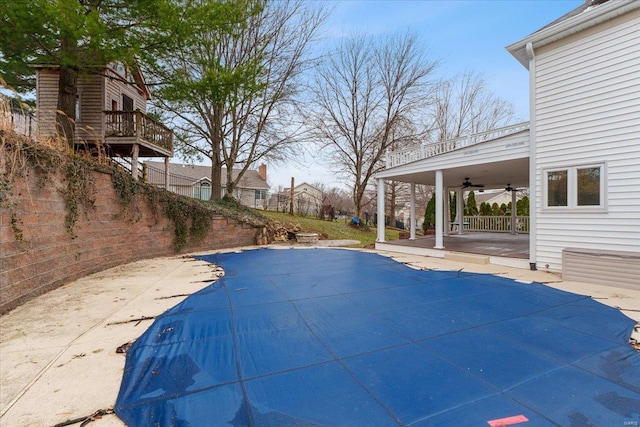 view of pool featuring a patio area, a fenced in pool, and a ceiling fan