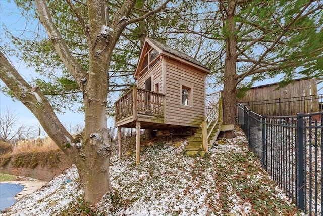 view of side of property featuring fence, a deck, and stairs