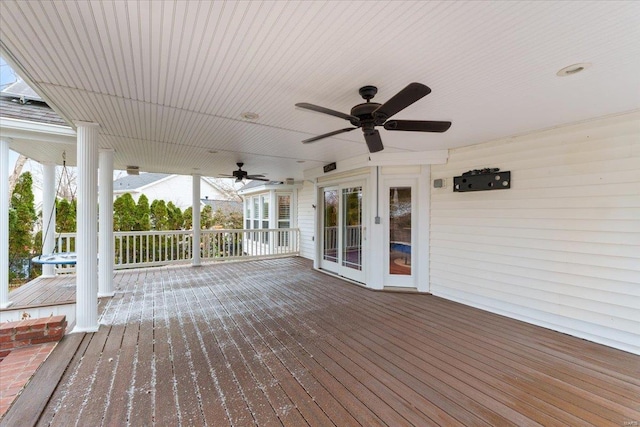 wooden deck featuring a ceiling fan