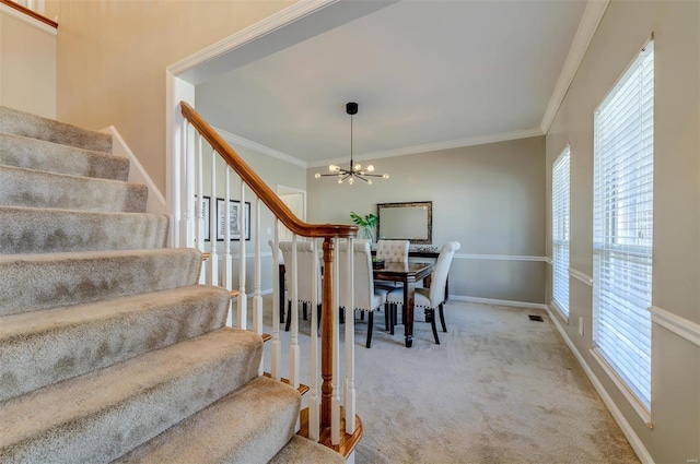 dining space with carpet floors, ornamental molding, and a wealth of natural light