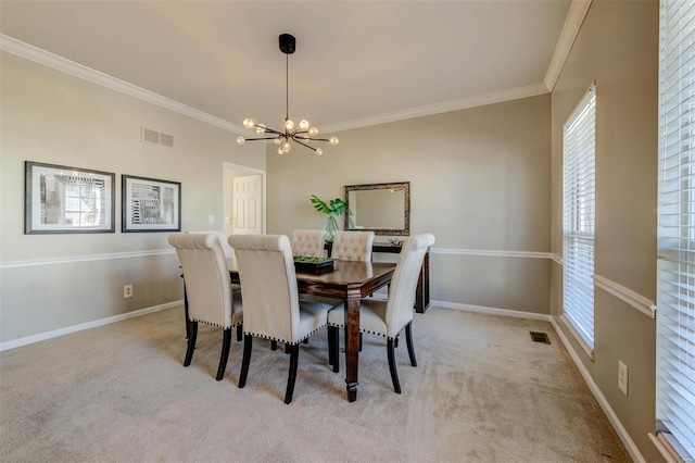 dining area featuring a chandelier, visible vents, and carpet flooring