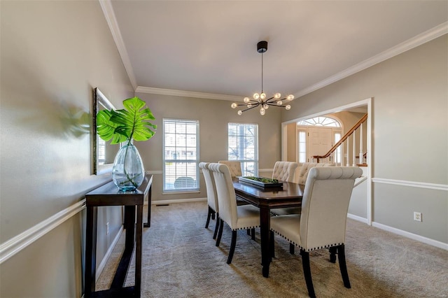 carpeted dining area with baseboards, a chandelier, and ornamental molding