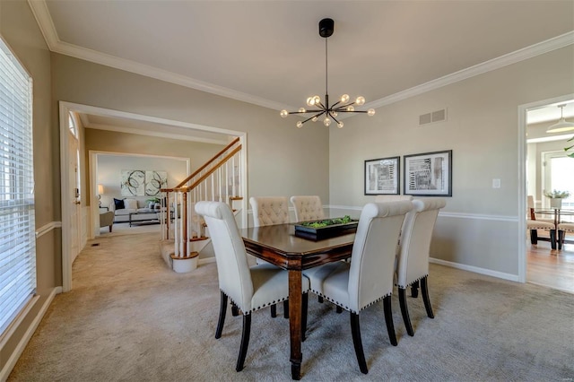 dining space with light colored carpet, visible vents, crown molding, and an inviting chandelier