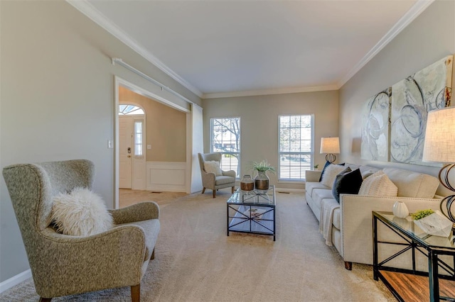 living room featuring carpet floors, wainscoting, ornamental molding, and a decorative wall