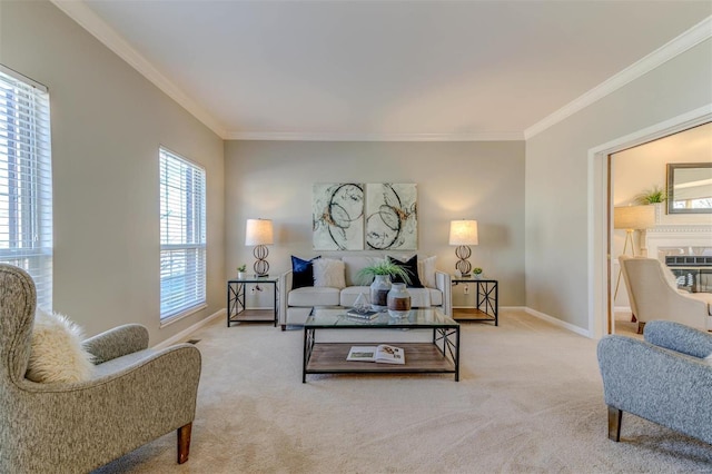 carpeted living area with baseboards, a glass covered fireplace, and crown molding