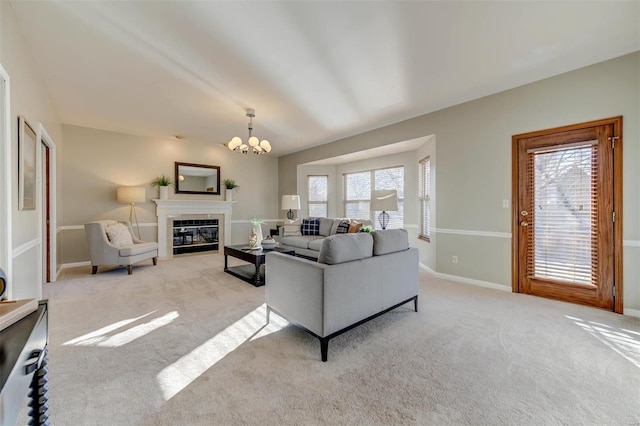 living room featuring a notable chandelier, carpet flooring, and a healthy amount of sunlight