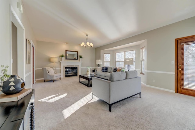 living room featuring light carpet, a chandelier, and a wealth of natural light