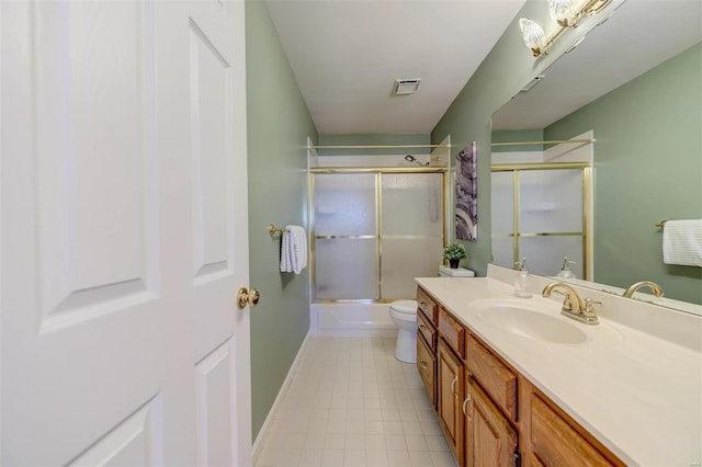 bathroom featuring visible vents, toilet, vanity, tile patterned flooring, and baseboards