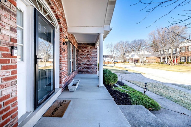 view of patio featuring a porch and a residential view