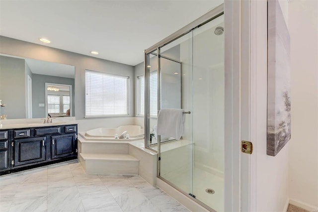 bathroom with a stall shower, marble finish floor, a bath, and vanity