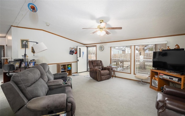 carpeted living area featuring plenty of natural light, ornamental molding, ceiling fan, and a textured ceiling