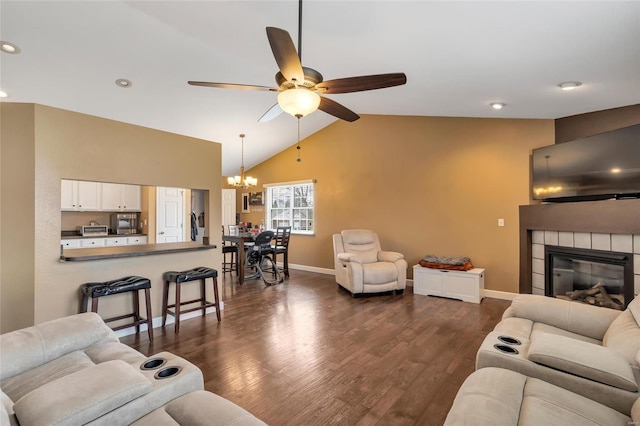 living area featuring lofted ceiling, a fireplace, baseboards, and dark wood-type flooring