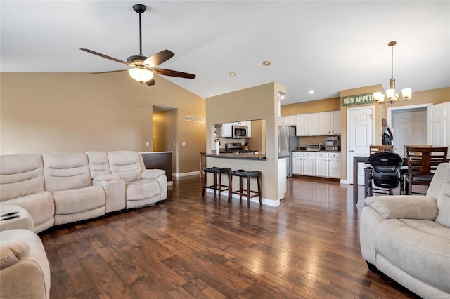 living room with baseboards, dark wood-type flooring, ceiling fan with notable chandelier, vaulted ceiling, and recessed lighting