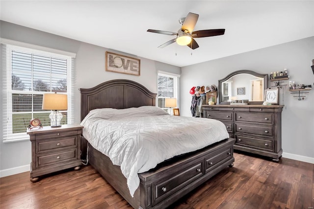 bedroom with dark wood-style floors, ceiling fan, and baseboards