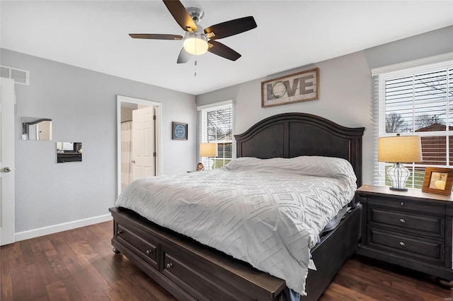 bedroom with dark wood-style floors, visible vents, a ceiling fan, connected bathroom, and baseboards