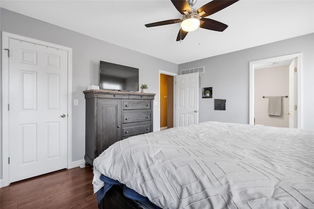 bedroom featuring baseboards, visible vents, dark wood finished floors, and a ceiling fan