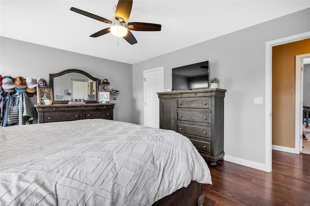 bedroom featuring ceiling fan, baseboards, and wood finished floors