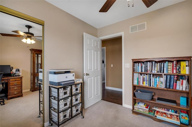 carpeted office with ceiling fan, visible vents, and baseboards