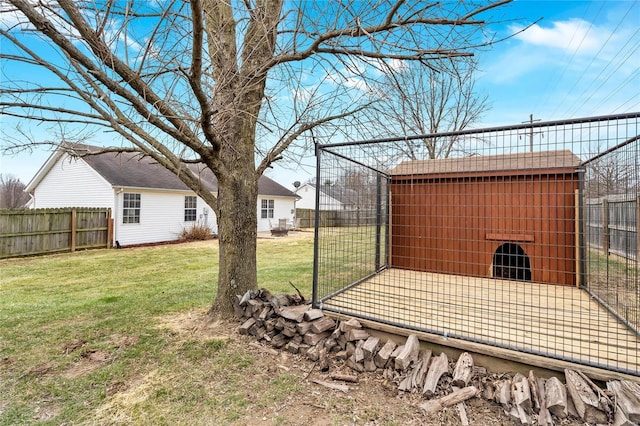 view of yard featuring an outbuilding and fence