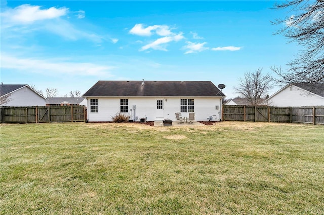 back of house with a patio, a lawn, and a fenced backyard