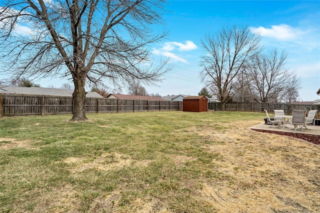 view of yard with a patio area, an outdoor structure, a fenced backyard, and a storage shed