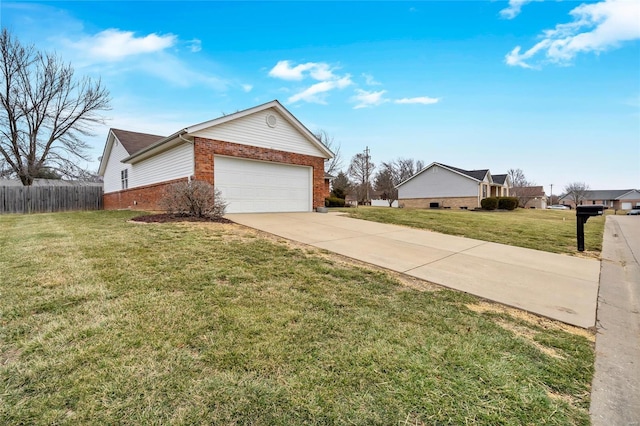 view of side of property with a yard, driveway, brick siding, and fence