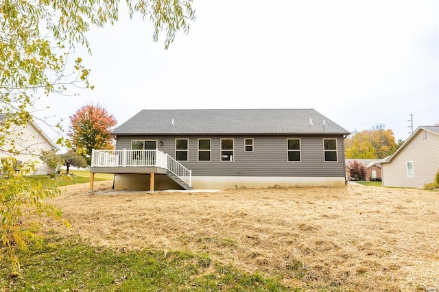 rear view of house featuring stairway and a deck