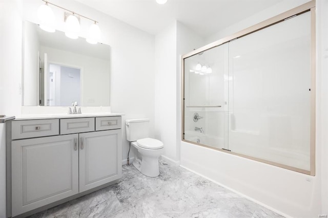 full bathroom with baseboards, toilet, enclosed tub / shower combo, marble finish floor, and vanity