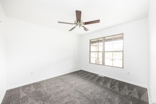 carpeted spare room featuring visible vents, a ceiling fan, and baseboards