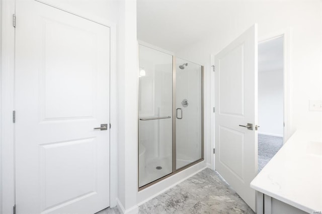 full bath featuring a stall shower and marble finish floor