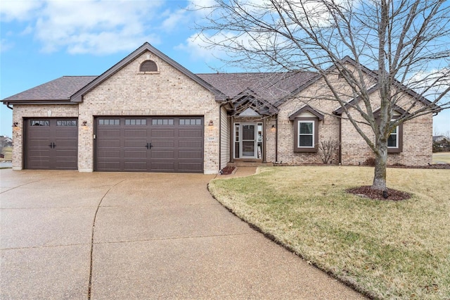 view of front of property with a garage, driveway, a front lawn, and brick siding