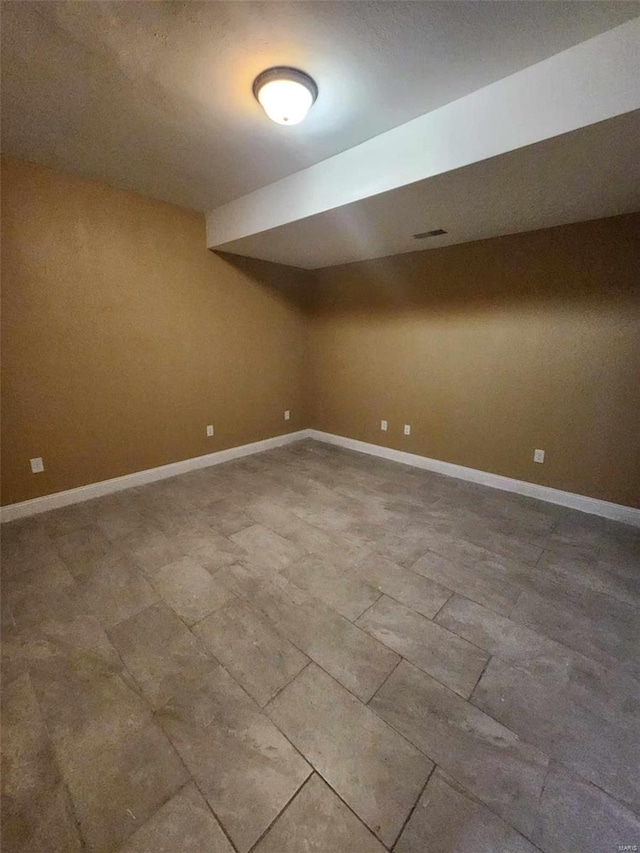 finished basement featuring visible vents and baseboards