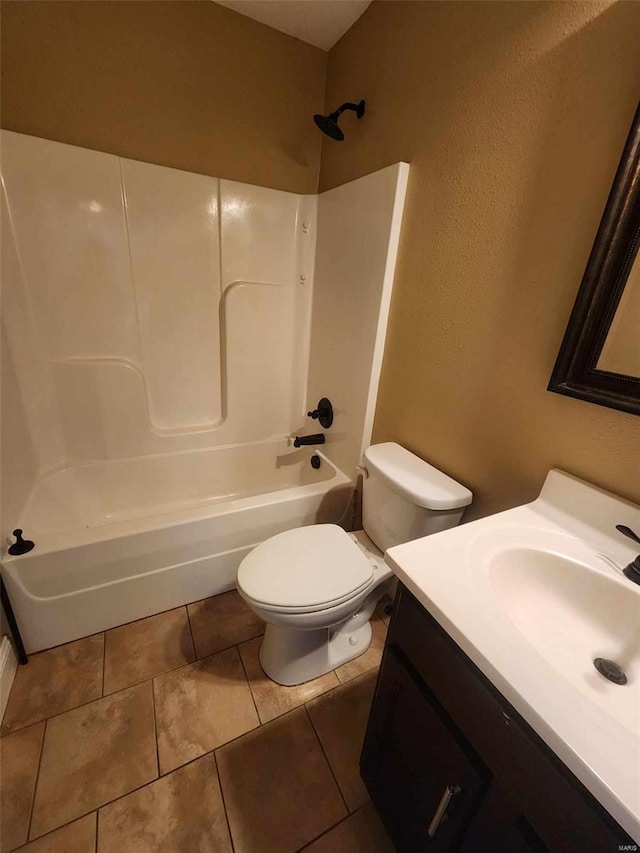 full bath with washtub / shower combination, tile patterned flooring, vanity, and toilet