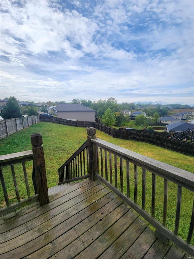 wooden deck featuring a lawn and a fenced backyard