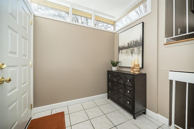 interior space with light tile patterned floors and baseboards