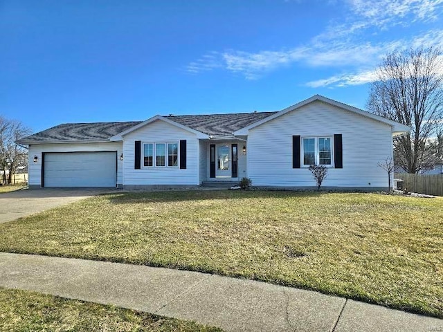 ranch-style house featuring an attached garage, driveway, and a front yard