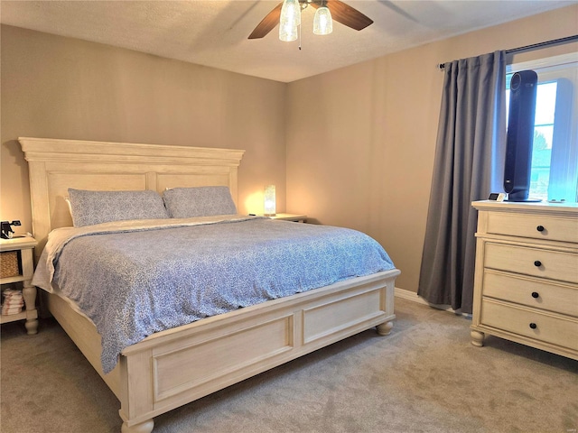 bedroom with light carpet and ceiling fan