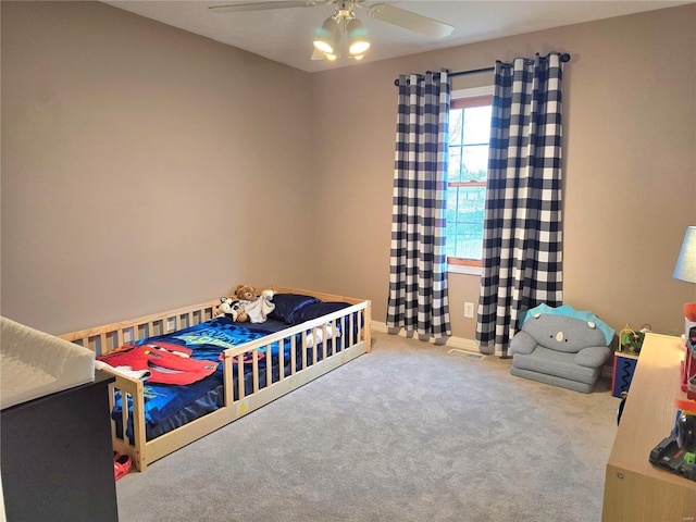 bedroom featuring ceiling fan, carpet floors, visible vents, and baseboards